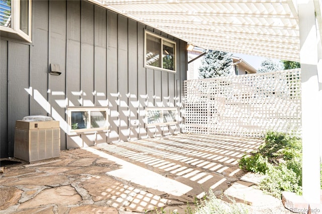 view of patio / terrace with a pergola and cooling unit