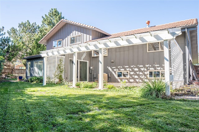 rear view of house with a lawn and a pergola