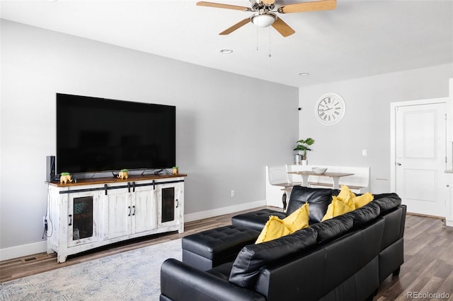 living room with wood-type flooring and ceiling fan