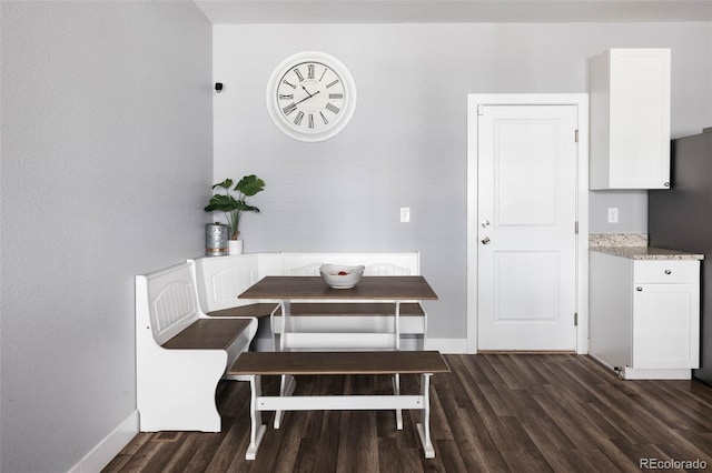 dining space with dark hardwood / wood-style flooring and breakfast area