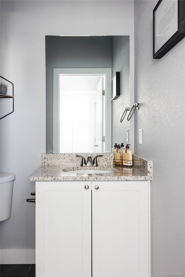 bathroom featuring vanity and toilet