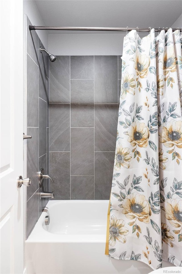 bathroom with shower / bath combination with curtain