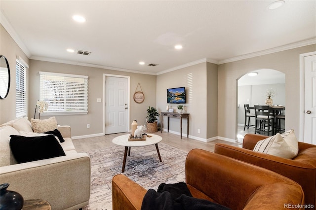 living room featuring ornamental molding and light hardwood / wood-style floors