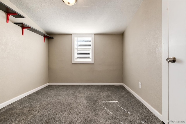 unfurnished room with a textured wall, a textured ceiling, baseboards, and carpet floors