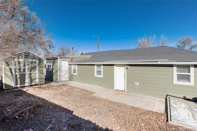 back of house with an outbuilding