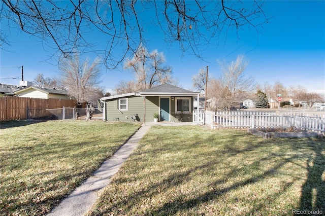 back of property with a lawn and a fenced backyard