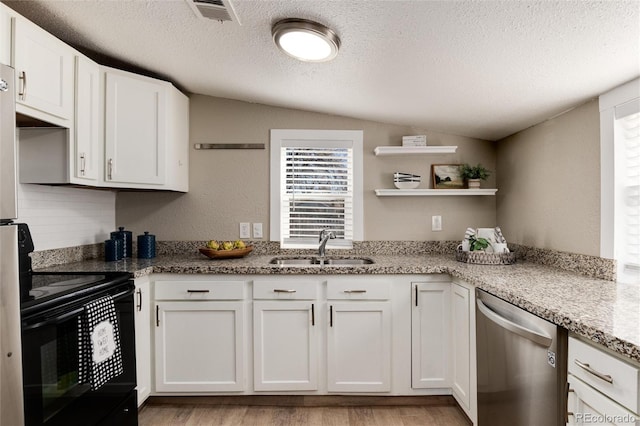 kitchen with electric range, visible vents, a sink, lofted ceiling, and dishwasher