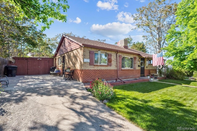 9301 Ciancio St, Thornton, CO 80229 - view of front facade with brick siding, a gate, a chimney, and a patio area