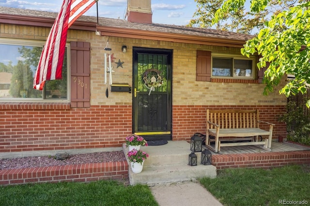 9301 Ciancio St, Thornton, CO 80229 - view of exterior entry with brick siding and a chimney