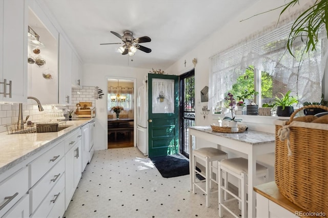 9301 Ciancio St, Thornton, CO 80229 - kitchen with a sink, freestanding refrigerator, ceiling fan, and healthy amount of natural light
