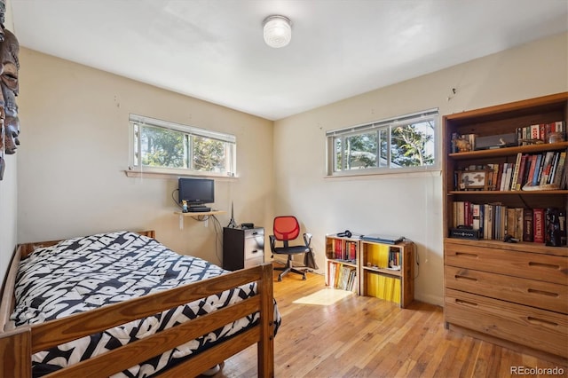 9301 Ciancio St, Thornton, CO 80229 - bedroom featuring multiple windows, light wood-style floors, and an office area