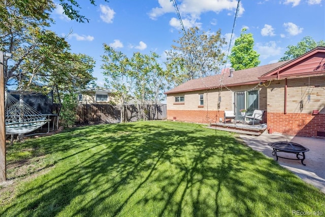 9301 Ciancio St, Thornton, CO 80229 - view of yard featuring a fire pit, a trampoline, and a patio area