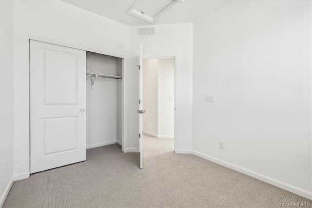 unfurnished bedroom featuring baseboards, a closet, visible vents, and carpet flooring