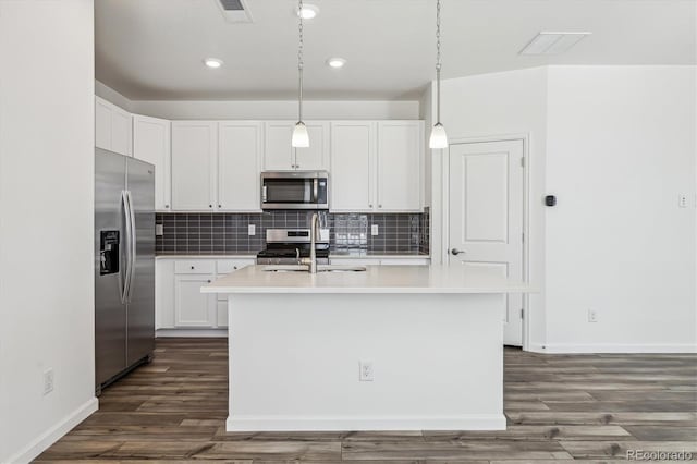 kitchen with tasteful backsplash, visible vents, appliances with stainless steel finishes, light countertops, and a sink