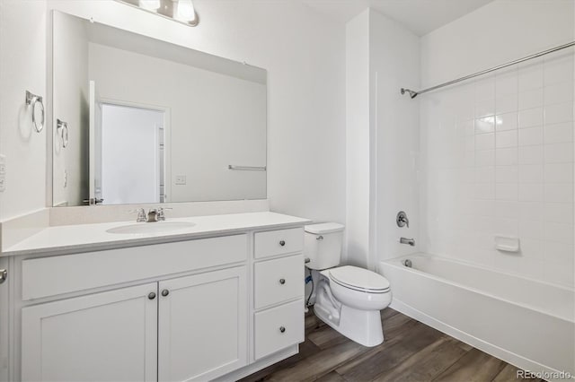 full bathroom with toilet, bathtub / shower combination, wood finished floors, and vanity