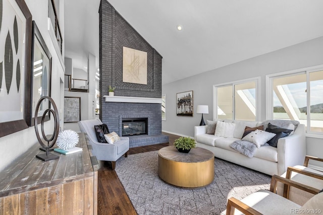 living room featuring dark hardwood / wood-style flooring, a brick fireplace, and vaulted ceiling