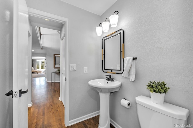 bathroom featuring hardwood / wood-style floors, sink, and toilet