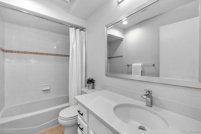 full bathroom with shower / bath combination with curtain, vanity, and toilet