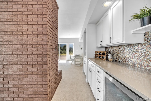 kitchen with white cabinetry, decorative backsplash, and wine cooler