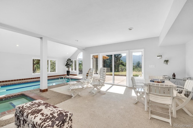 carpeted living room with vaulted ceiling