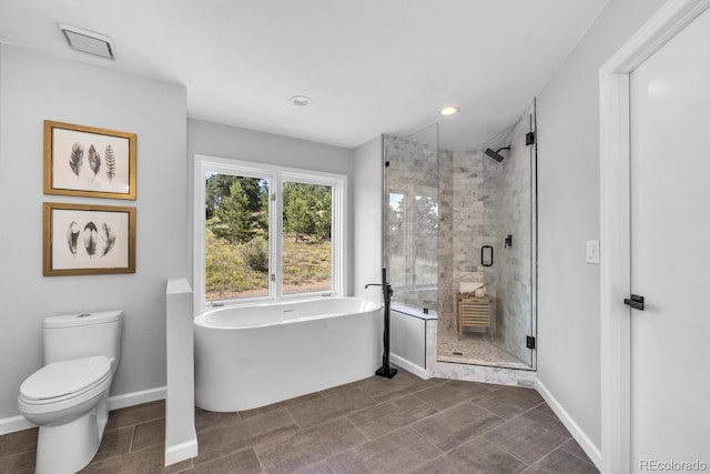 bathroom featuring toilet and shower with separate bathtub