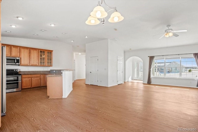 kitchen featuring hanging light fixtures, appliances with stainless steel finishes, ceiling fan with notable chandelier, and light hardwood / wood-style flooring