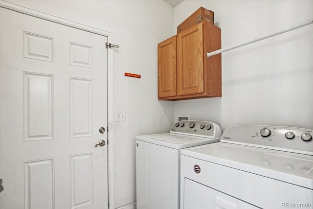 laundry area with cabinets and separate washer and dryer