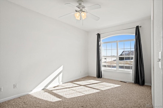 carpeted spare room with ceiling fan