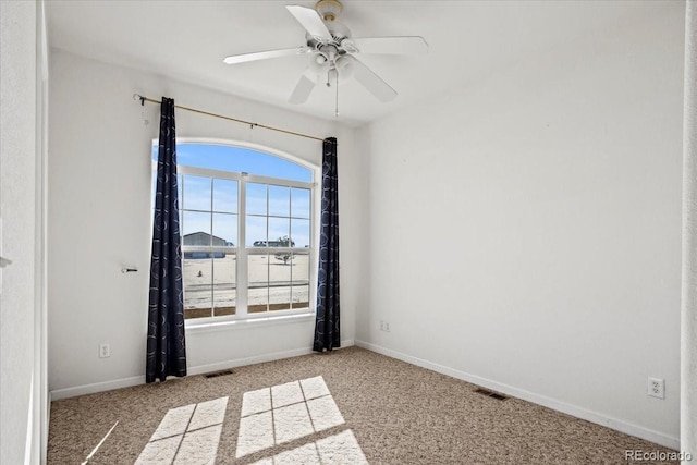 unfurnished room with light colored carpet and ceiling fan