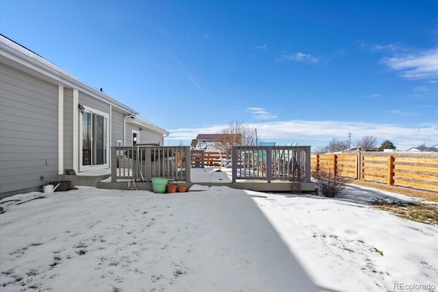 snowy yard featuring a deck