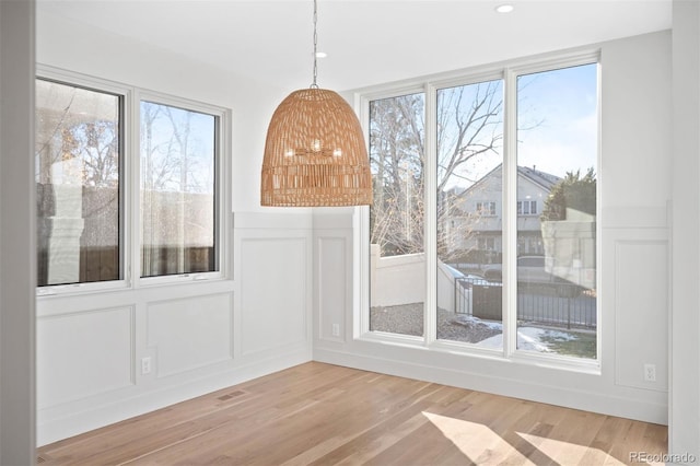 unfurnished dining area with light hardwood / wood-style flooring