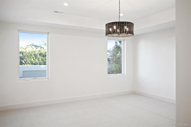 unfurnished room with carpet flooring and an inviting chandelier