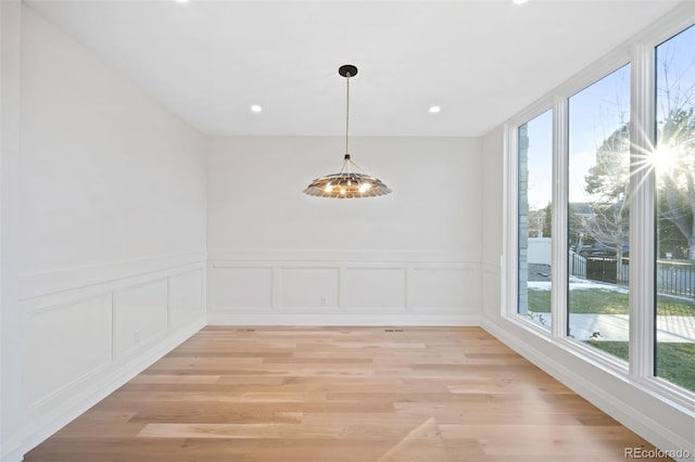 unfurnished dining area featuring a wealth of natural light and light hardwood / wood-style flooring