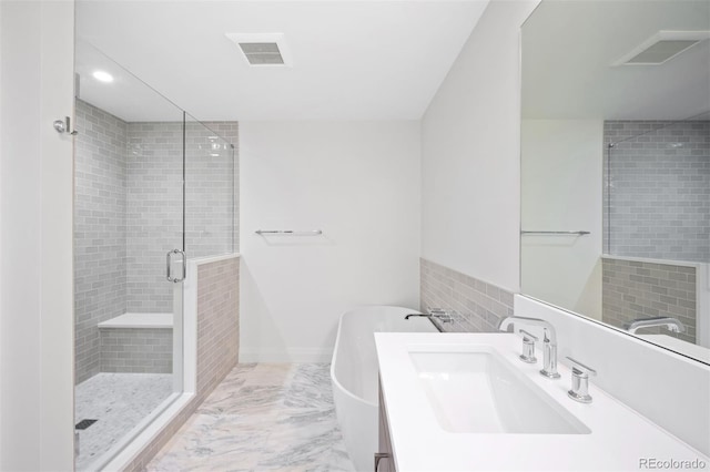 bathroom featuring an enclosed shower and sink