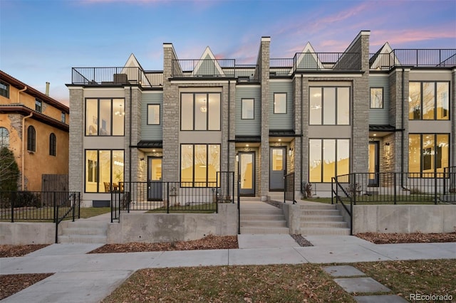 view of front of home featuring a balcony