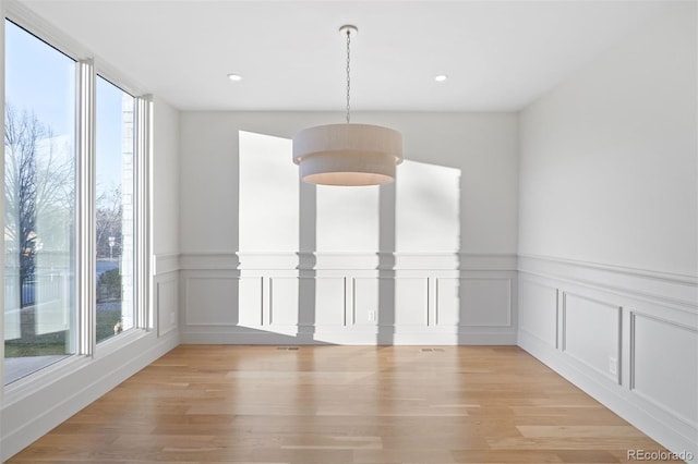 unfurnished dining area with light wood-type flooring