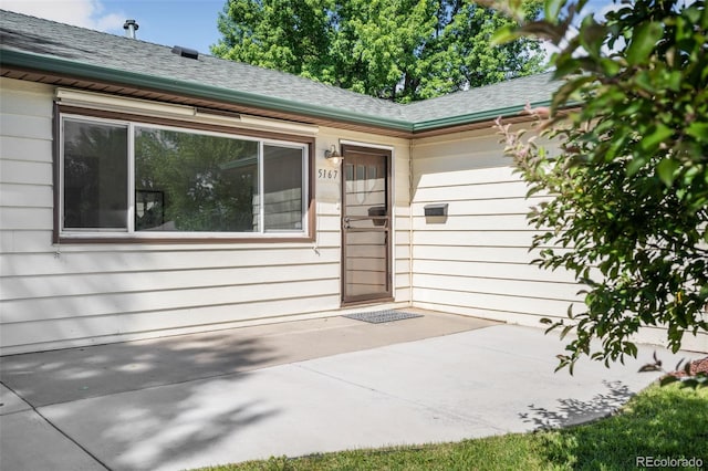 5167 S Pearl St, Littleton, CO 80121 - doorway to property with a shingled roof and a patio area