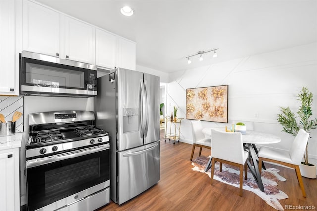 5167 S Pearl St, Littleton, CO 80121 - kitchen with appliances with stainless steel finishes, white cabinetry, wood finished floors, light countertops, and recessed lighting