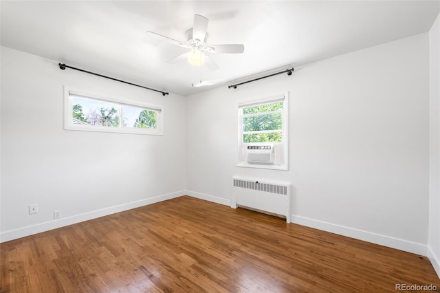 5167 S Pearl St, Littleton, CO 80121 - empty room with radiator heating unit, cooling unit, wood finished floors, and a ceiling fan