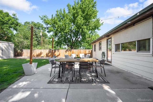 5167 S Pearl St, Littleton, CO 80121 - fenced backyard featuring outdoor dining area, a patio area, and a shed