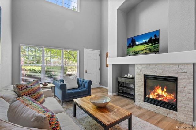 14300 Waterside Ln Unit E3, Broomfield, CO 80023 - living area with a high ceiling, wood finished floors, and a fireplace