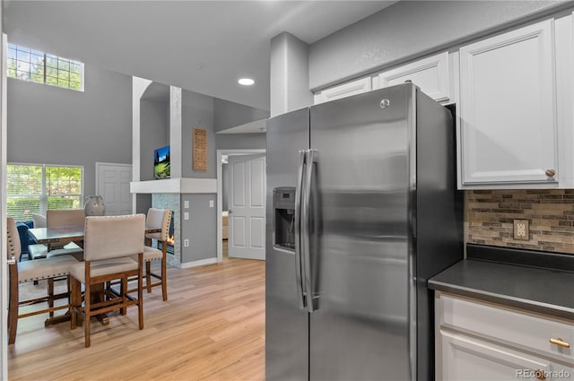 14300 Waterside Ln Unit E3, Broomfield, CO 80023 - kitchen featuring stainless steel fridge with ice dispenser, decorative backsplash, light wood-style floors, white cabinetry, and recessed lighting