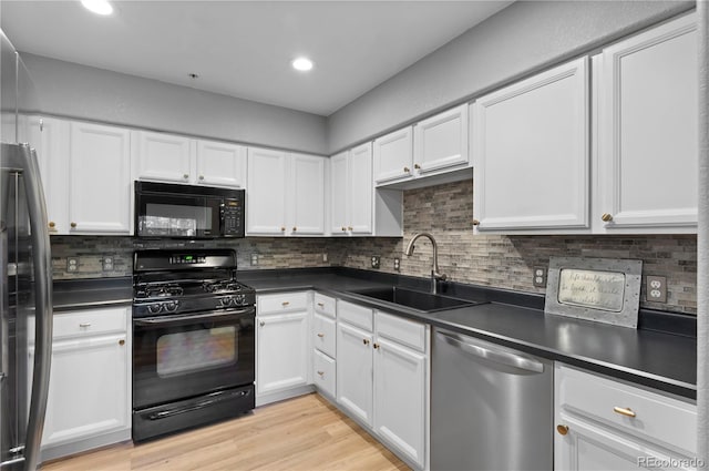 14300 Waterside Ln Unit E3, Broomfield, CO 80023 - kitchen featuring black appliances, dark countertops, white cabinetry, decorative backsplash, and recessed lighting