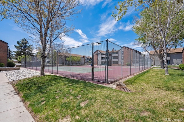 view of sport court featuring fence, a gate, and a yard