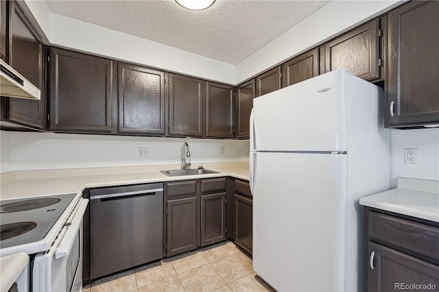 kitchen with light tile patterned flooring, dark brown cabinetry, a sink, white appliances, and light countertops