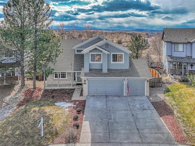 traditional home with fence, concrete driveway, and roof with shingles