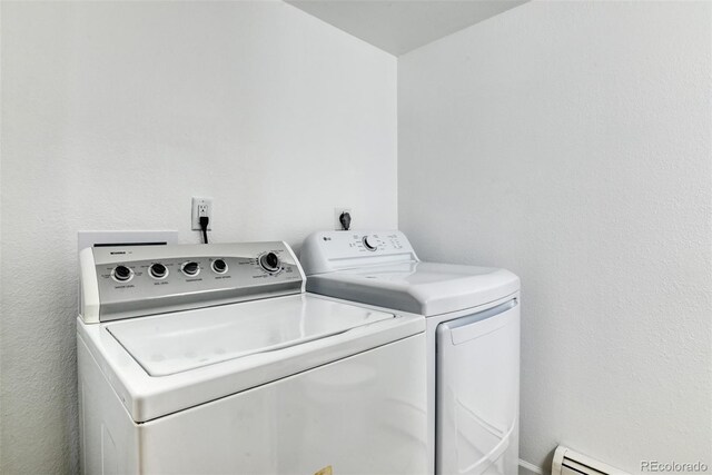 laundry room with separate washer and dryer and a baseboard radiator