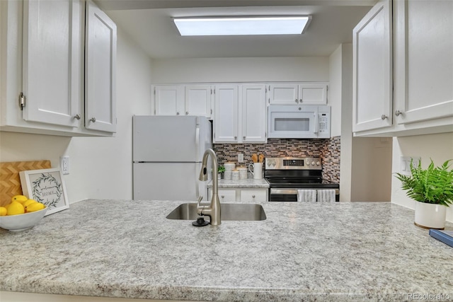 kitchen with white cabinets, white appliances, backsplash, and sink