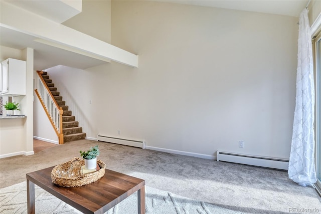 unfurnished living room with light colored carpet and baseboard heating