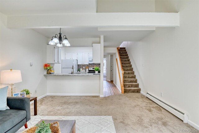 carpeted living room featuring beam ceiling, a chandelier, and a baseboard radiator